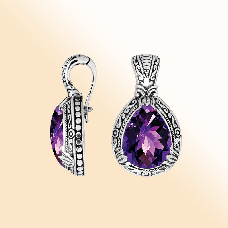 Handcrafted sterling silver pendant featuring a faceted Amethyst Quartz teardrop with artistic Balinese detailing and a glossy polished finish.