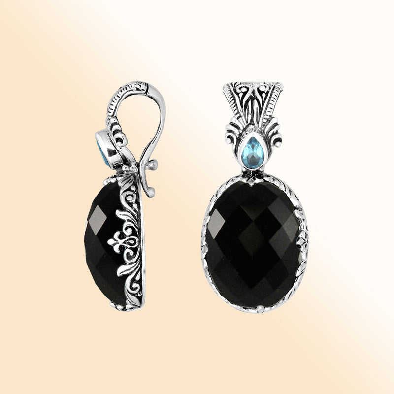 Handcrafted sterling silver pendant featuring Black Onyx and Blue Topaz Quartz with artistic Balinese detailing and a polished glossy finish.