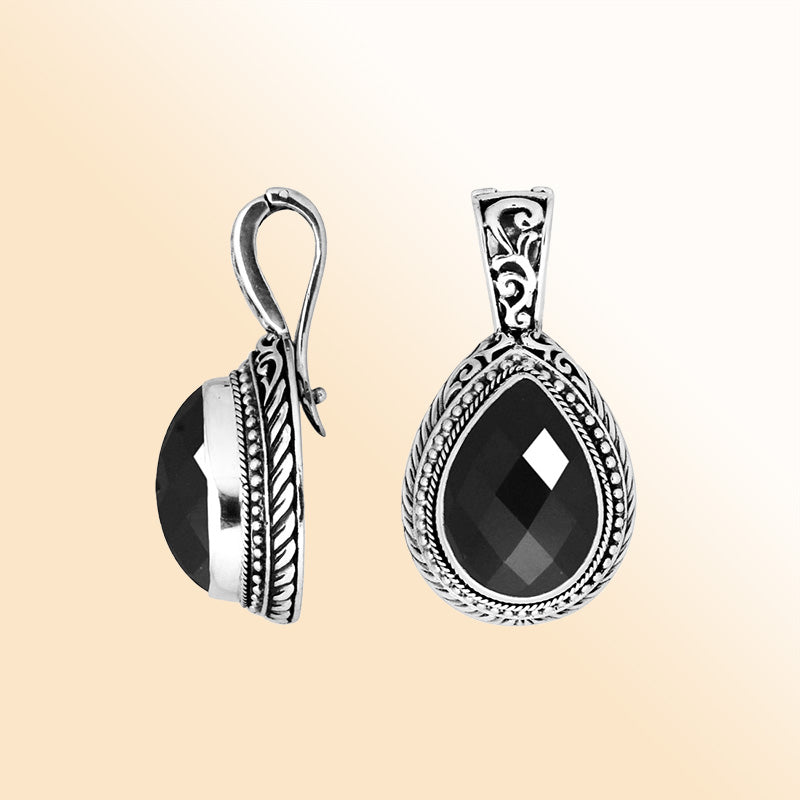 Handcrafted sterling silver teardrop pendant featuring faceted Black Onyx with artistic Balinese detailing and a polished glossy finish.