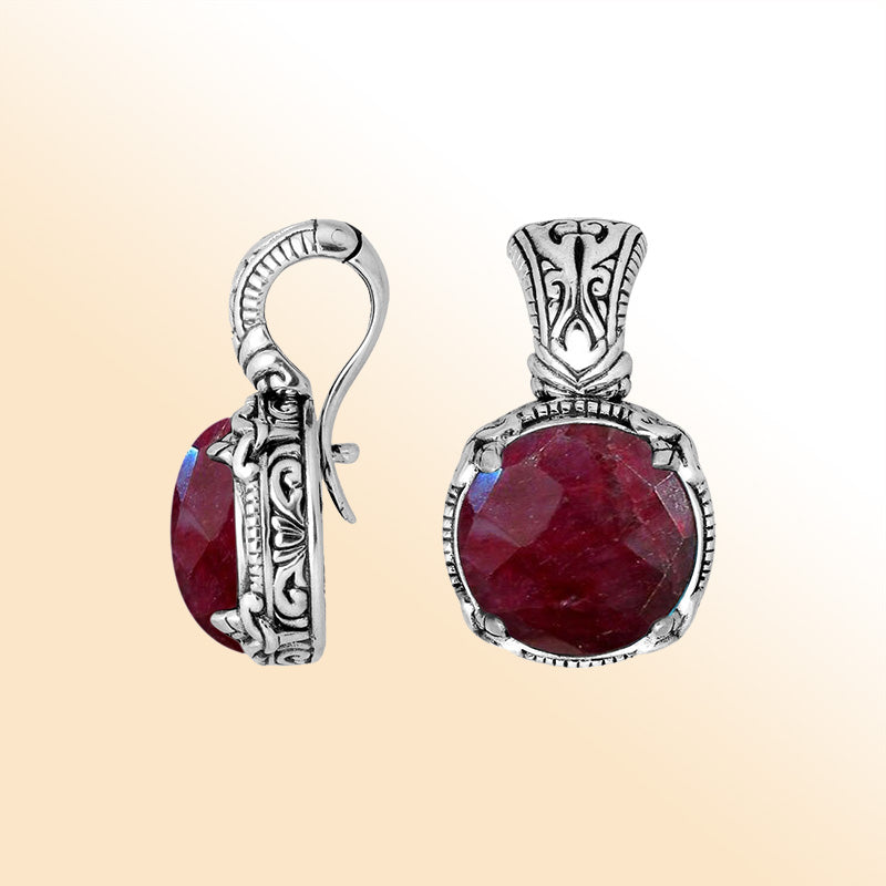 Handcrafted sterling silver cushion pendant featuring vivid Ruby Quartz and artistic Balinese detailing.