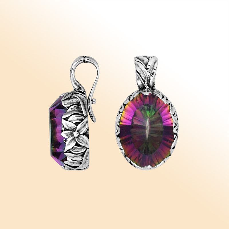 Elegant sterling silver oval-shaped Mystic Quartz pendant with engraved floral detailing, enhancer bail, and high-polished finish, reflecting iridescent colors and artistic craftsmanship.