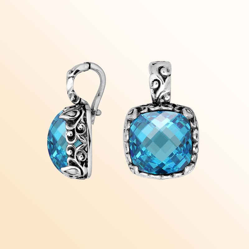Handcrafted sterling silver pendant featuring Blue Topaz Quartz with artistic Balinese scroll detailing.