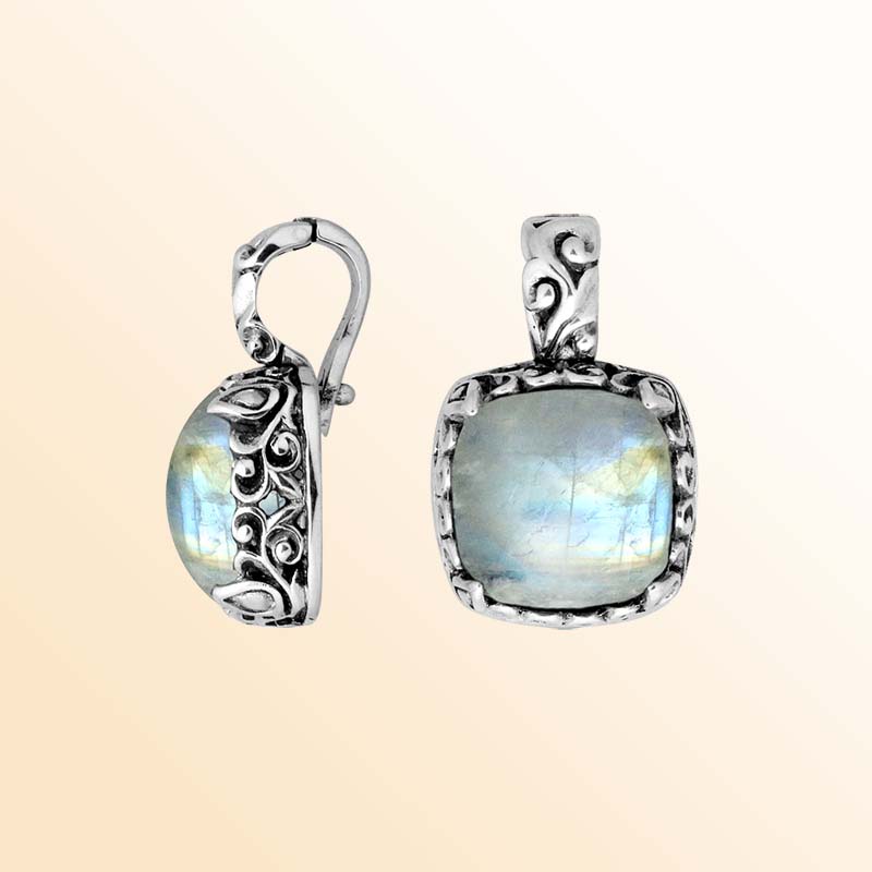 Handcrafted sterling silver pendant featuring Rainbow Moonstone with artistic Balinese scroll accents.