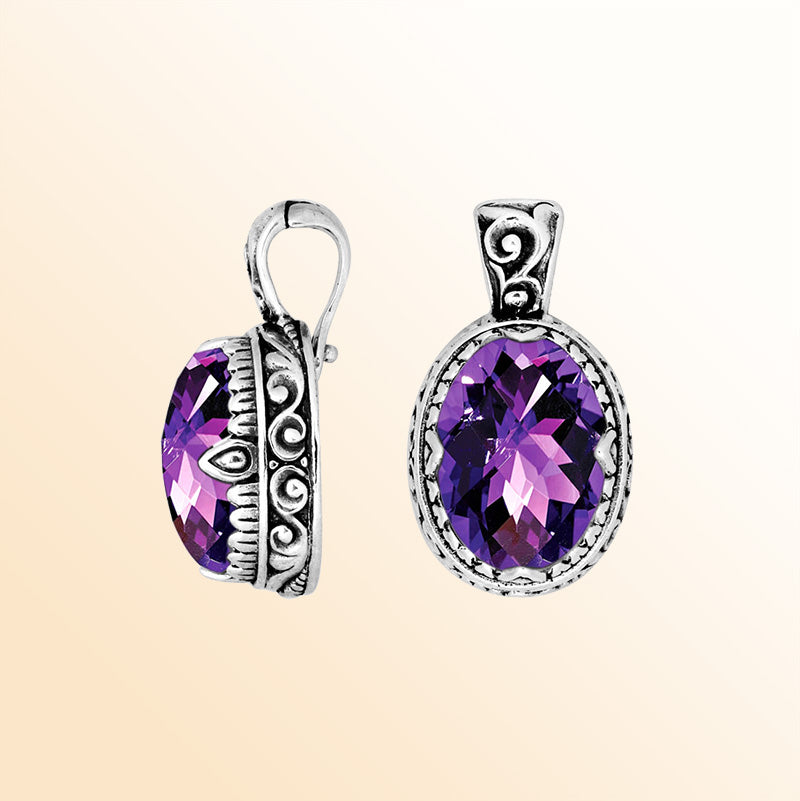 Handcrafted sterling silver pendant featuring an oval Amethyst Quartz centerpiece enhanced with smooth artistic scroll carvings and a polished decorative frame for expressive personal styling.