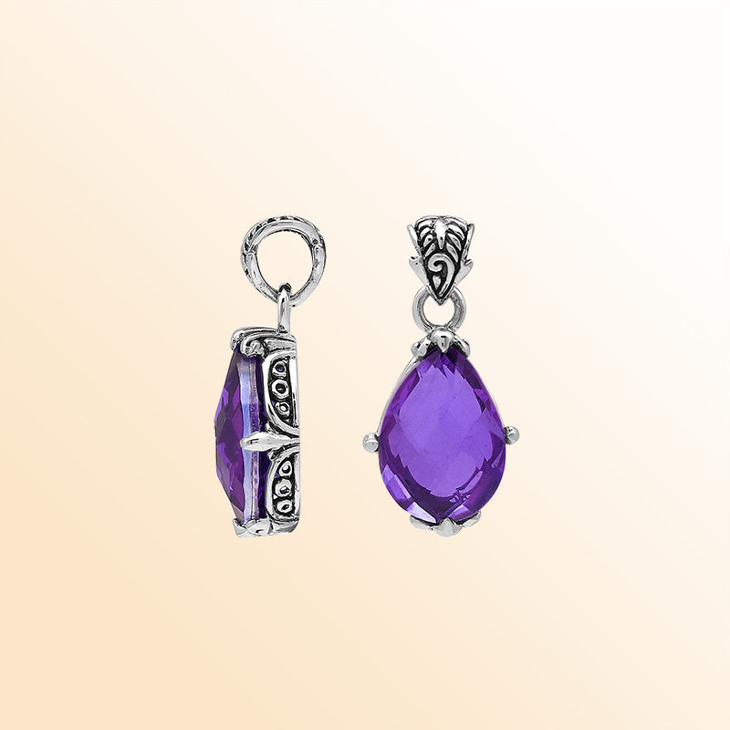 Handcrafted sterling silver pear-shaped pendant featuring a faceted Amethyst Quartz center with expressive prong work and graceful Balinese carved decorations.