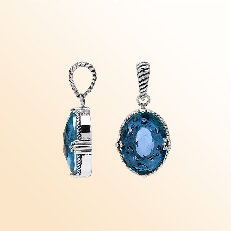 Handcrafted sterling silver pendant featuring London Blue Topaz Quartz in a rope-textured Balinese oval frame.