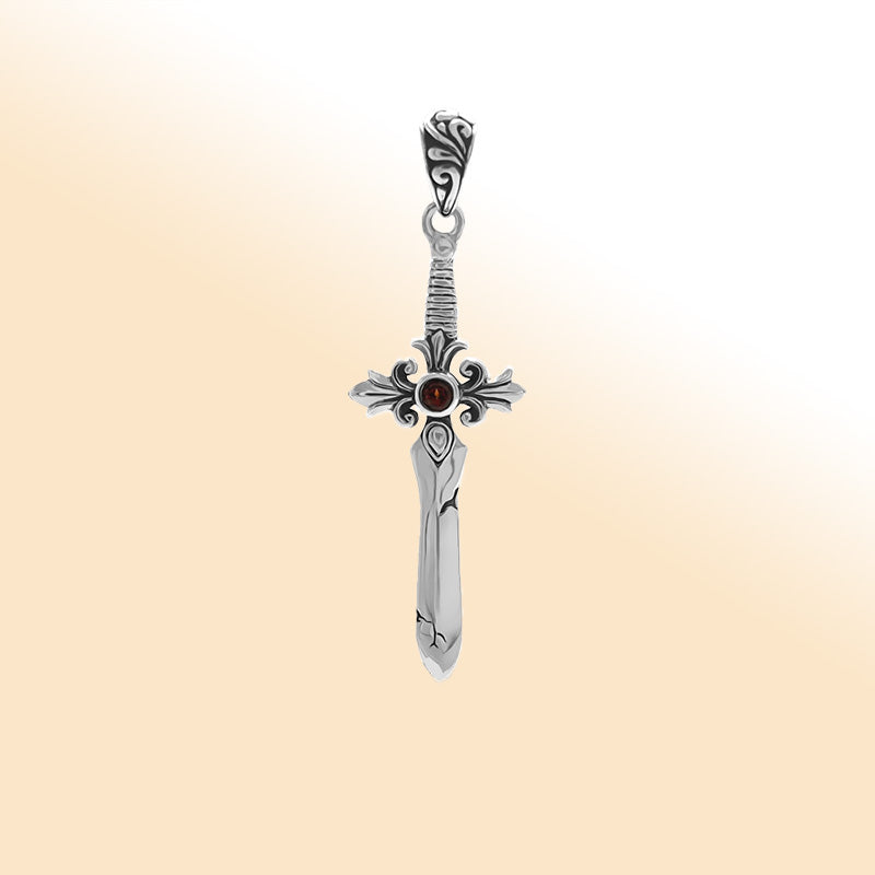 Artistic sterling silver sword pendant featuring a Red Garnet Quartz center stone and detailed filigree guard for expressive modern jewelry wearers