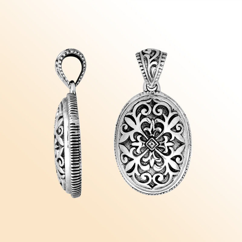 Artistic sterling silver oval pendant with floral carved motif.