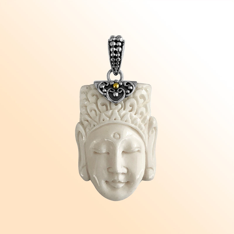 Artistic sterling silver pendant with hand-carved bone face and ornate accents.