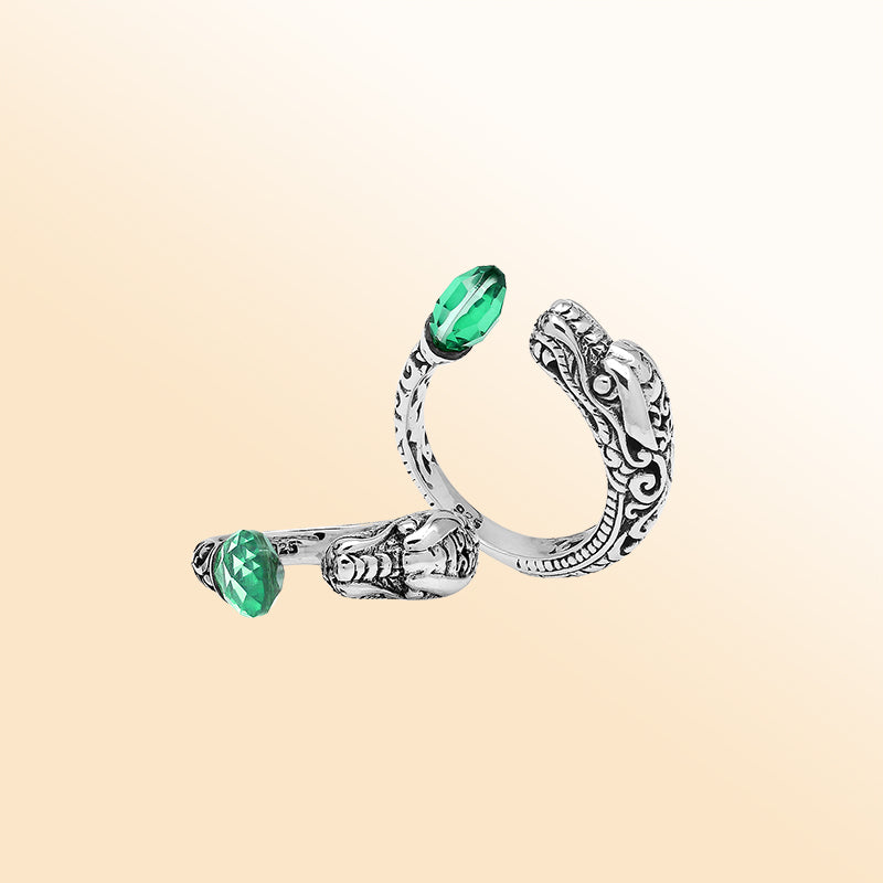Handcrafted sterling silver dragon ring with Green Quartz accents, detailed Balinese carvings, and adjustable open band design for unique artisan style.