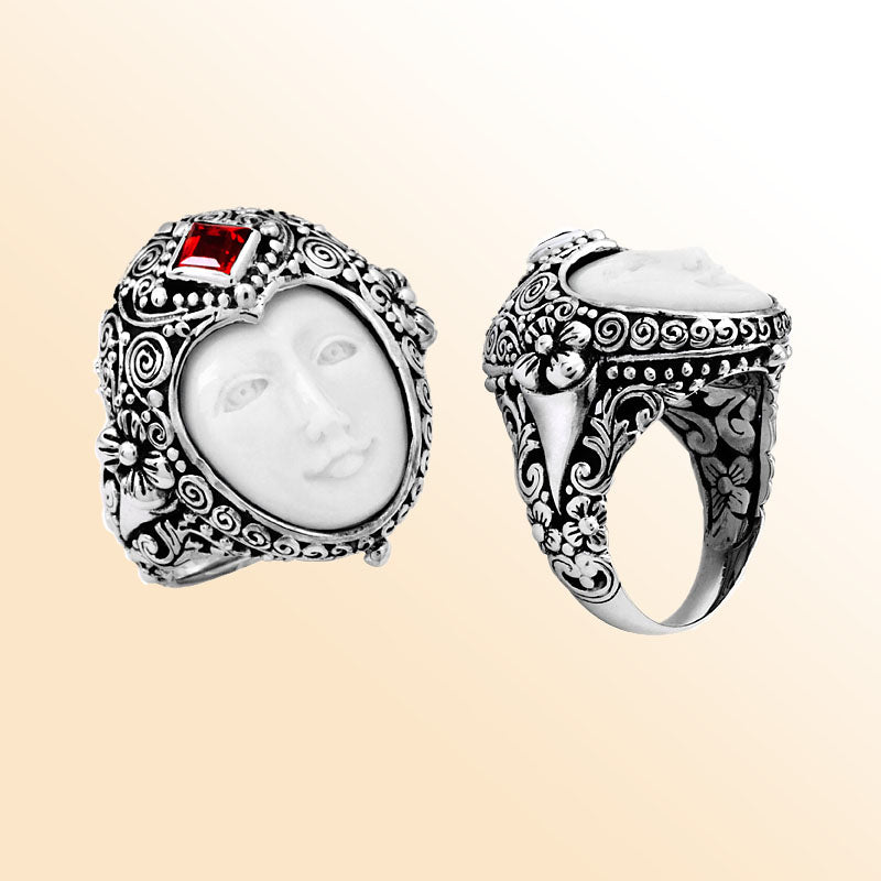 Handcrafted sterling silver ring with carved Bone Face, Garnet Quartz, and detailed Balinese floral design, unique artisan statement jewelry.