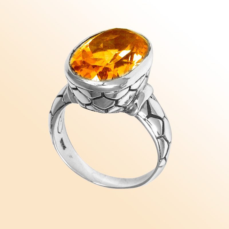 Handcrafted sterling silver ring with oval Citrine Quartz and artisan carved band, made in Bali.