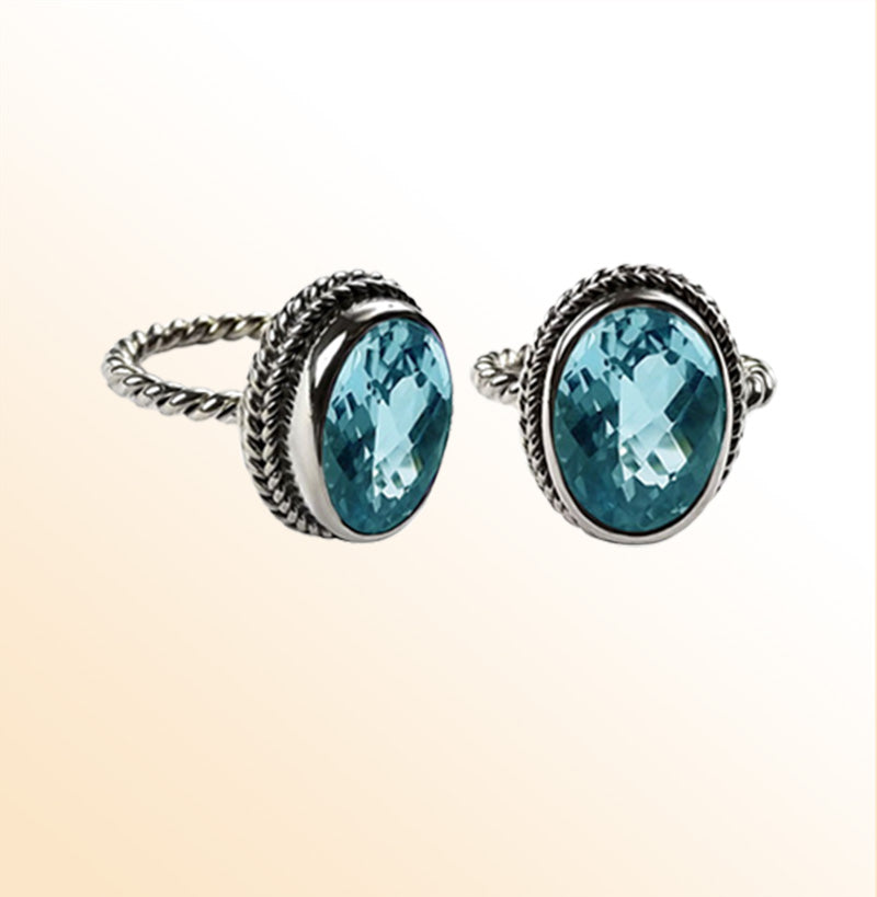 Handcrafted Bali silver ring with oval Blue Topaz Quartz and rope-style band.