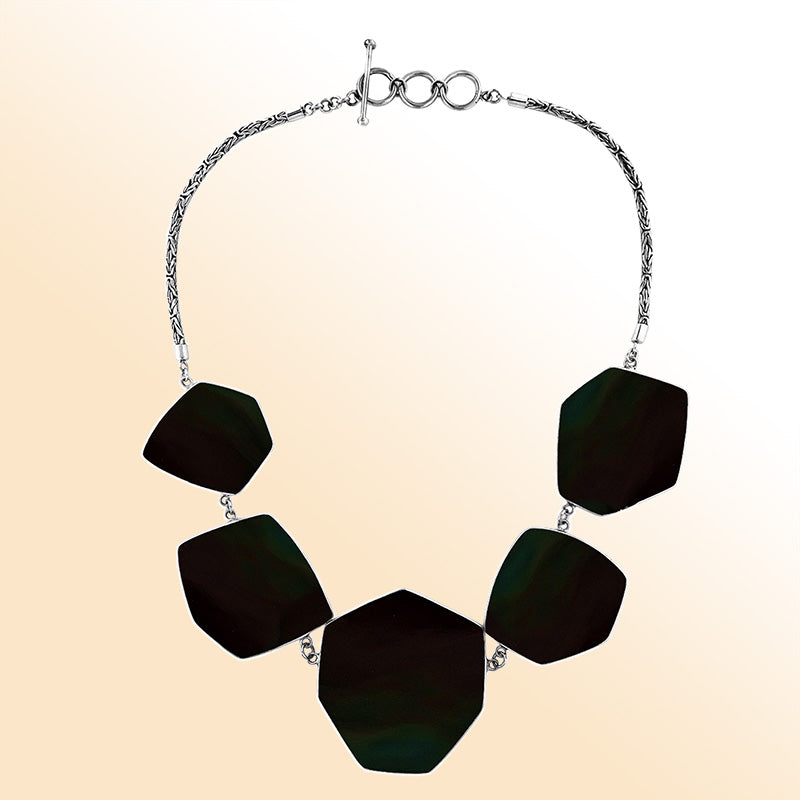 Handcrafted silver necklace with hexagon black shell links in artisan statement design.