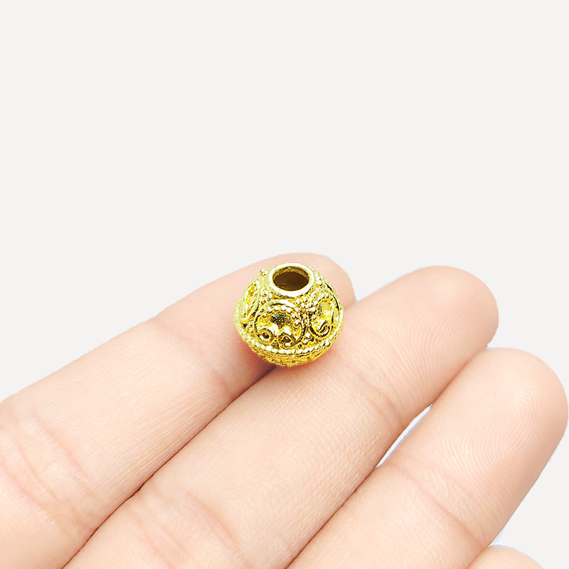 Handmade 18K gold overlay filigree copper bead with ornate scrollwork crafted in India.