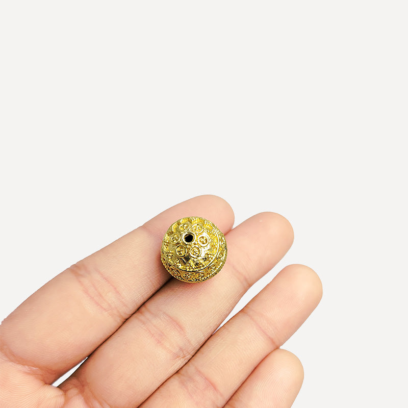Handcrafted 18K gold overlay copper bead with ornate granulated detailing from India for jewelry making.