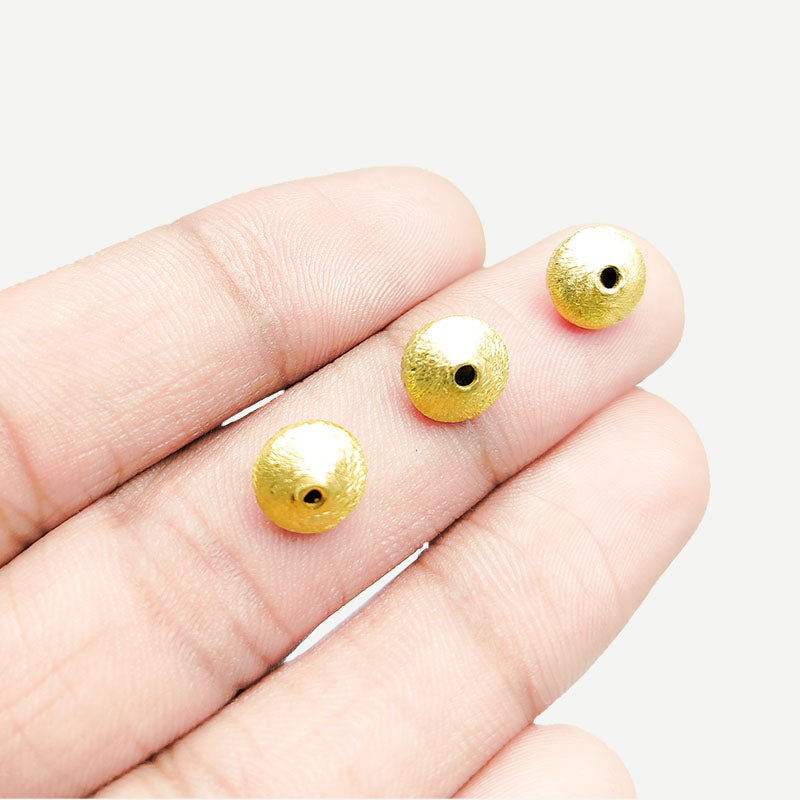 Handcrafted brushed bicone bead made from copper with 18K gold overlay, crafted in India.