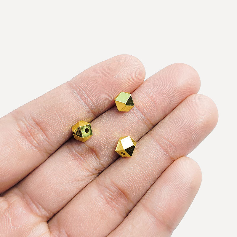 Handcrafted faceted geometric cube bead made of copper with 18K gold overlay, crafted in India.