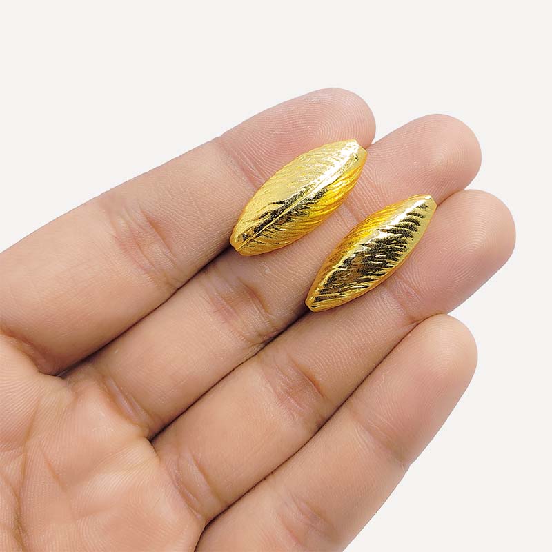 Elegant handcrafted twisted marquise bead made from 18K Gold Overlay Over Copper in India with polished gold finish.