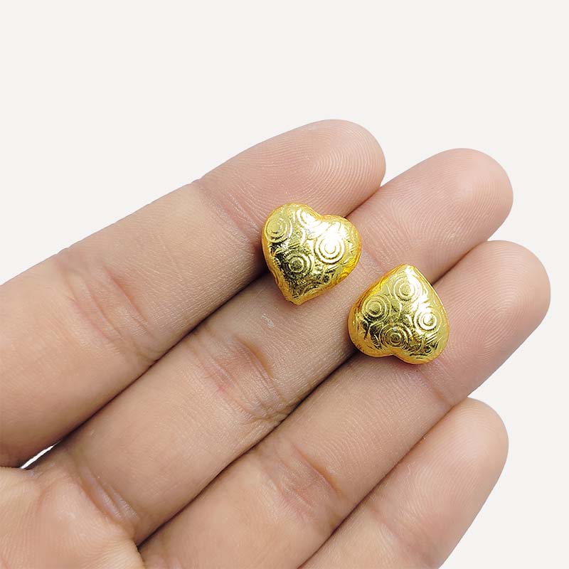 Elegant handcrafted heart-shaped bead made from 18K Gold Overlay Over Copper in India with engraved circular detailing.