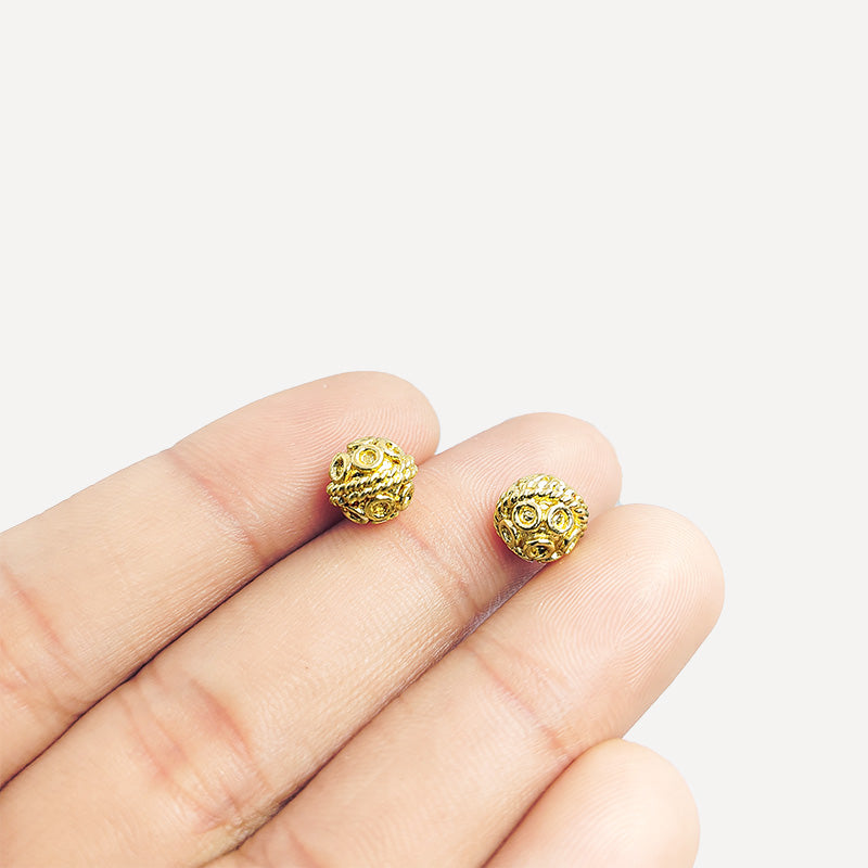 Elegant handcrafted openwork round bead made from 18K Gold Overlay Over Copper in India with decorative circular detailing.