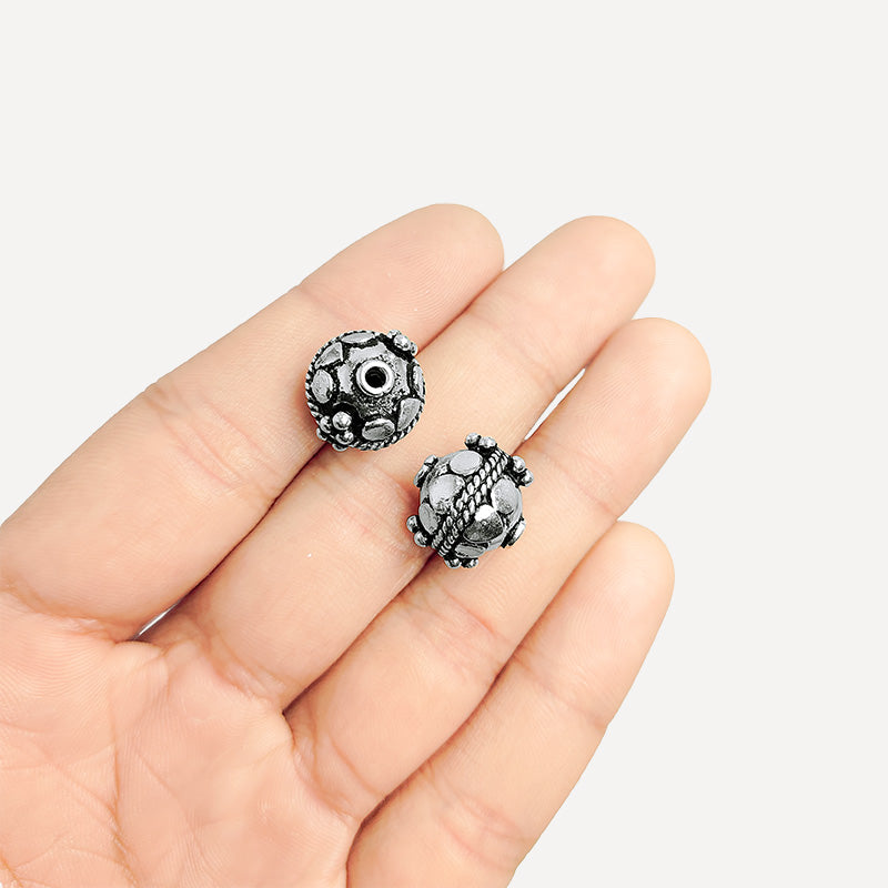 Handcrafted silver overlay round bead from India with oxidized finish and faceted motif design for retail jewelry making