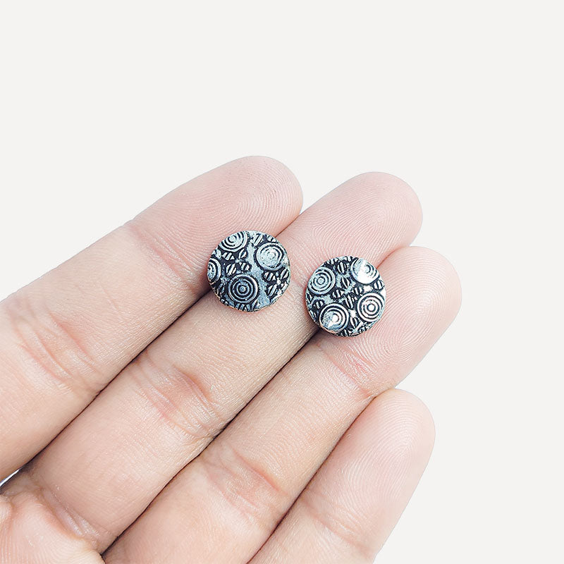 Single handcrafted silver and copper coin bead with detailed circle engraving for DIY jewelry design.