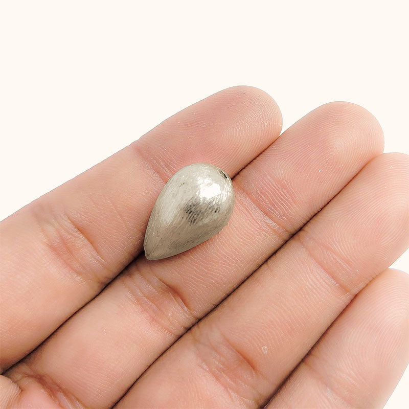 Elegant silver and copper teardrop shaped decor handcrafted in India with silver overlay finish