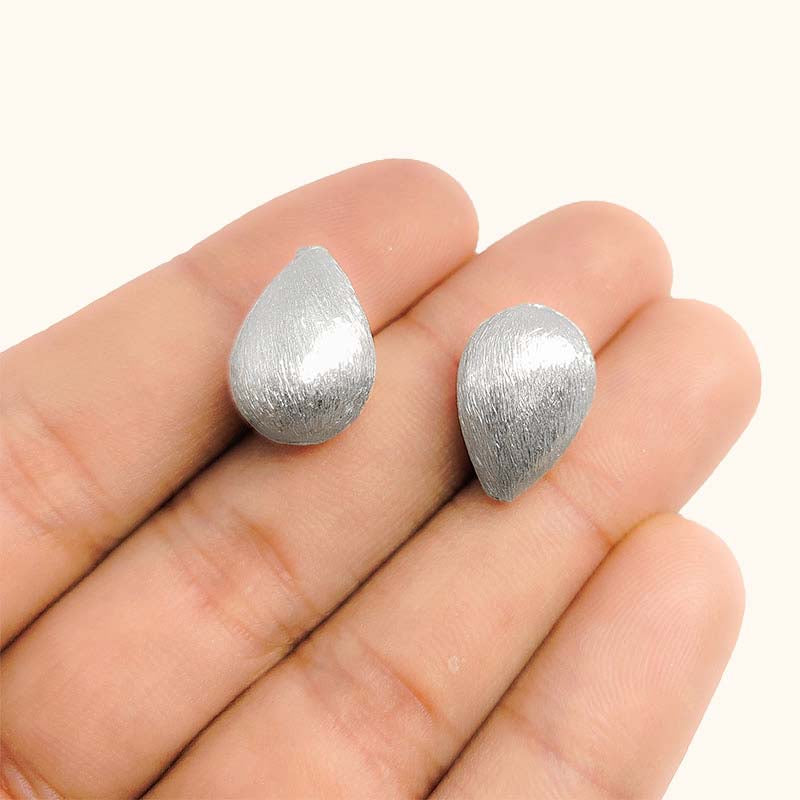 Elegant silver and copper pear shaped decor accent handcrafted in India with textured silver finish