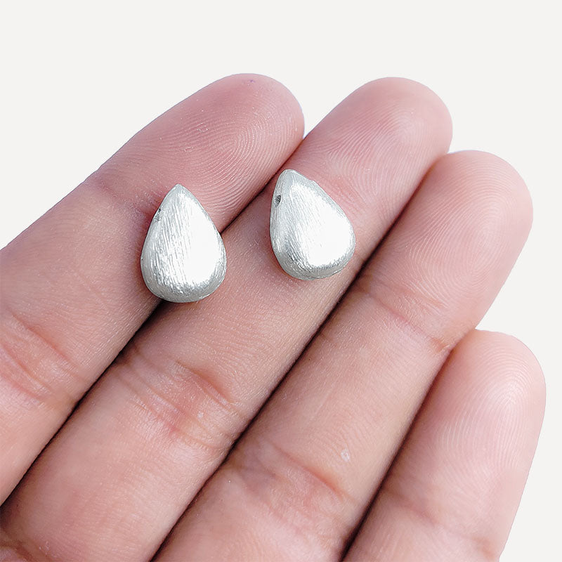 Delicate silver and copper teardrop bead accent handcrafted in India with textured silver finish