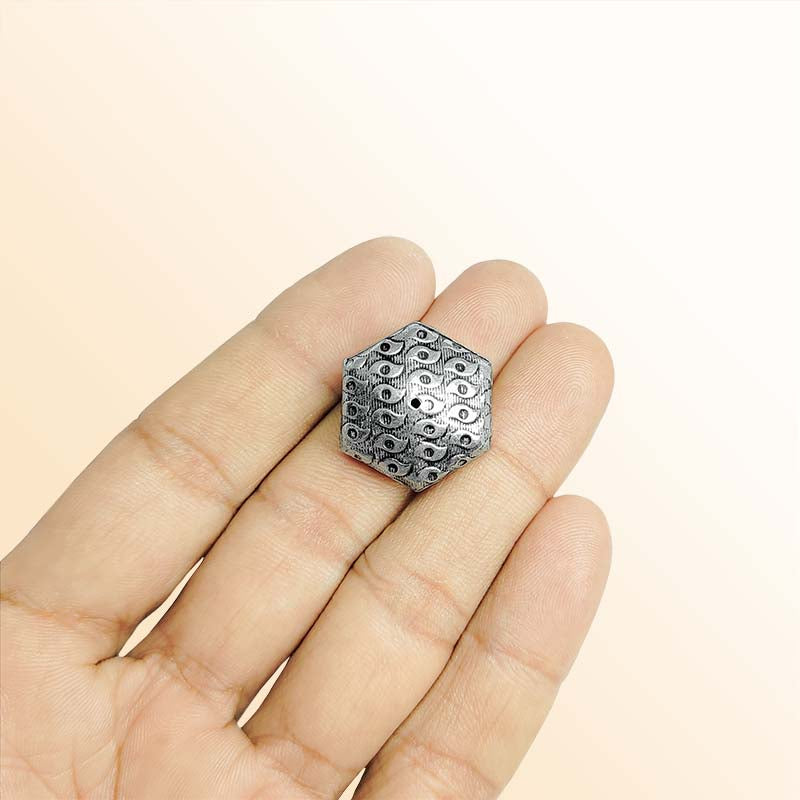 Silver hexagon bead cap from India with textured engraved design, handcrafted using silver overlay over copper.