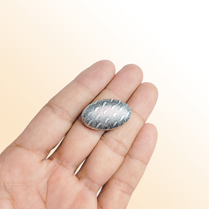 Silver oval dome bead cap from India with leaf and dot textured design, handcrafted using silver overlay over copper.