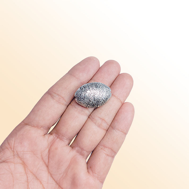 Silver floral oval bead cap from India with engraved leaf texture, handcrafted using silver overlay over copper.