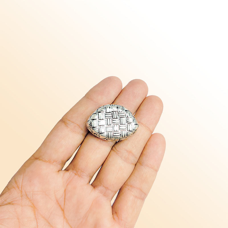 Silver oval bead cap from India with geometric textured design, handcrafted using silver overlay over copper.