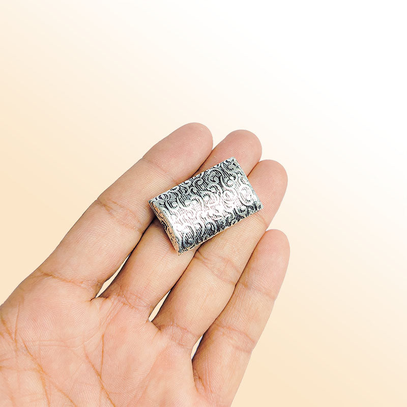 Silver rectangular bead cap from India with floral scroll textured design, handcrafted using silver overlay over copper.