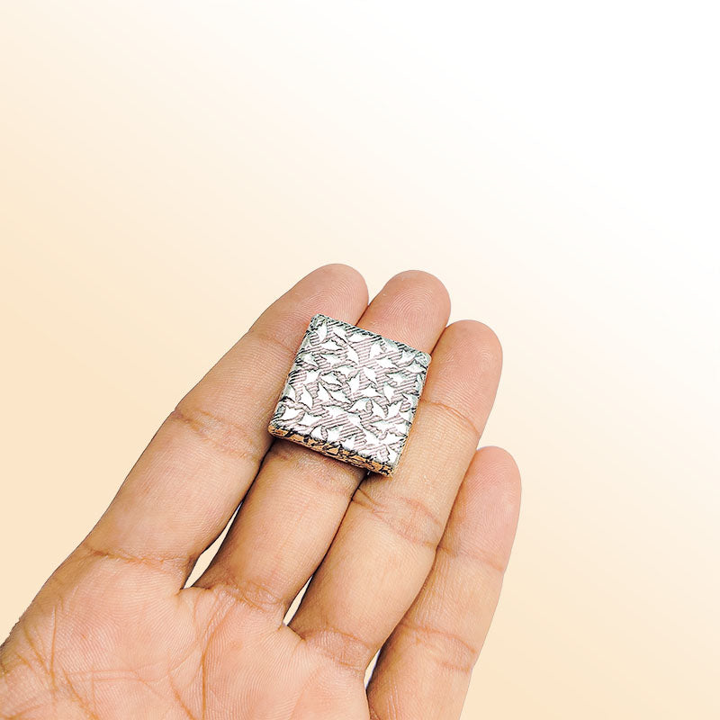 Handcrafted silver overlay over copper geometric bead from India with antique silver finish