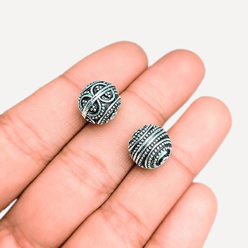 Textured silver overlay over copper round bead handcrafted in India with concentric dotted detailing