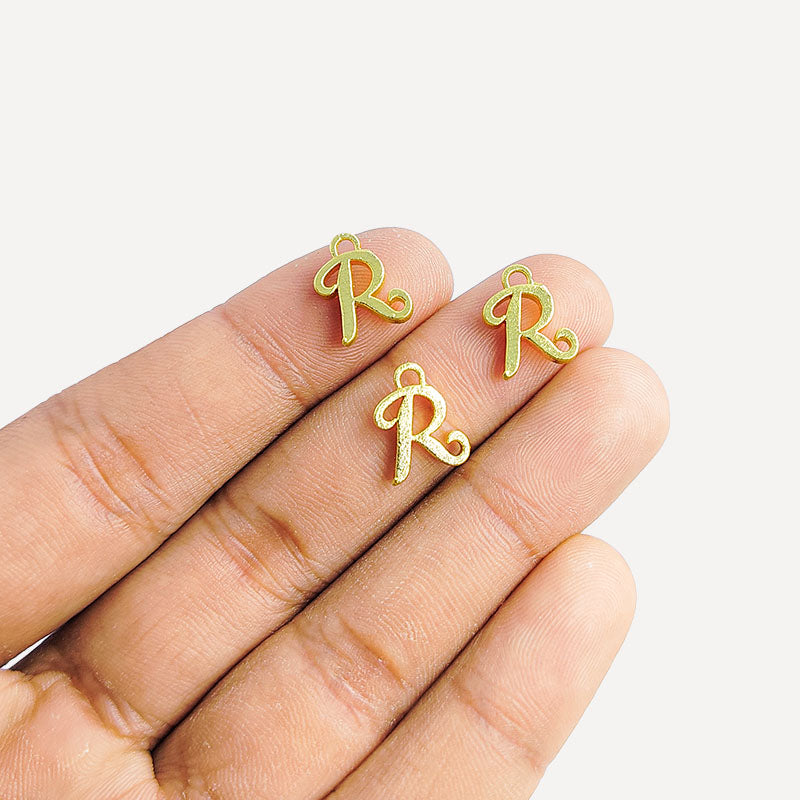 ‘R’ charm handcrafted in India featuring 18K Gold Overlay Over Copper with elegant textured finish.