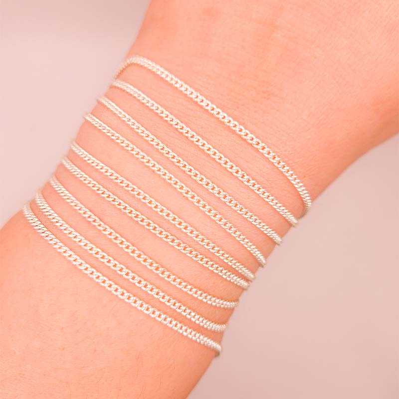 Silver overlay over copper beading and extender chain with polished curb links shown on white background for retail jewelry styling and customization