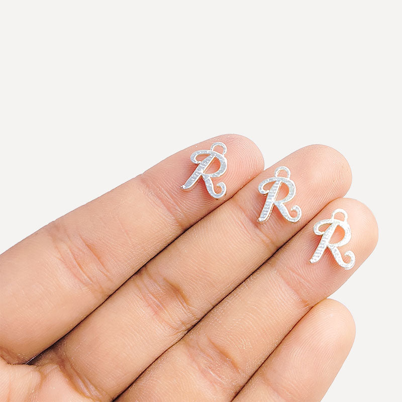 Handcrafted Silver Overlay Over Copper alphabet “R” charm from India with polished textured finish for handmade jewelry.