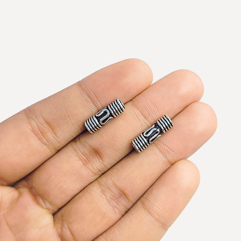 Cylindrical silver overlay tube bead over copper with engraved details and oxidized finish handcrafted in India for jewelry making