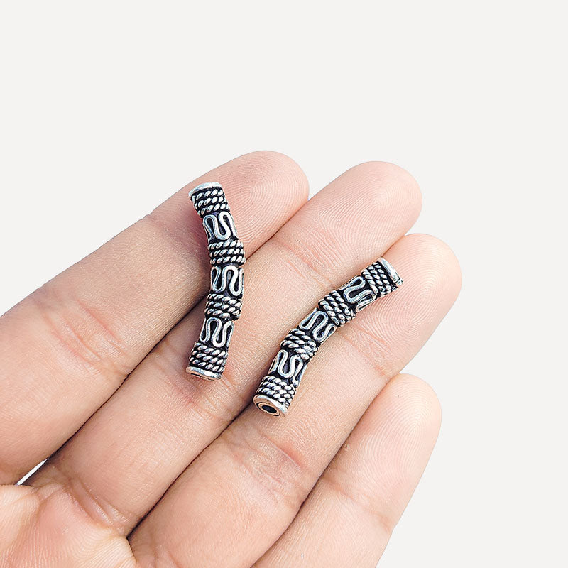 Handcrafted silver overlay over copper tube Bali curved charm from India with oxidized detailing and artisan design