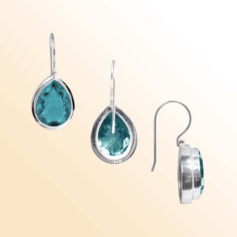 Handcrafted Sterling Silver earrings with pear-cut Blue Topaz Quartz featuring a polished bezel frame and graceful hook design.