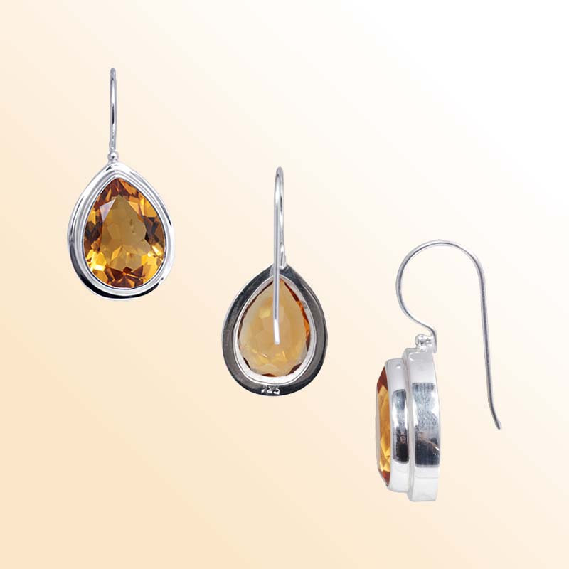 Handcrafted Sterling Silver earrings with pear-cut Citrine Quartz featuring a polished bezel frame and elegant hook design.