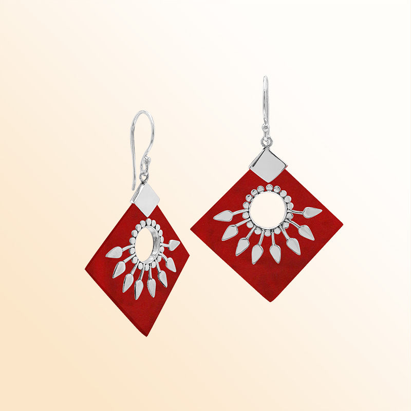 Handcrafted sterling silver earrings with Red Coral diamond shapes and silver sunburst design.