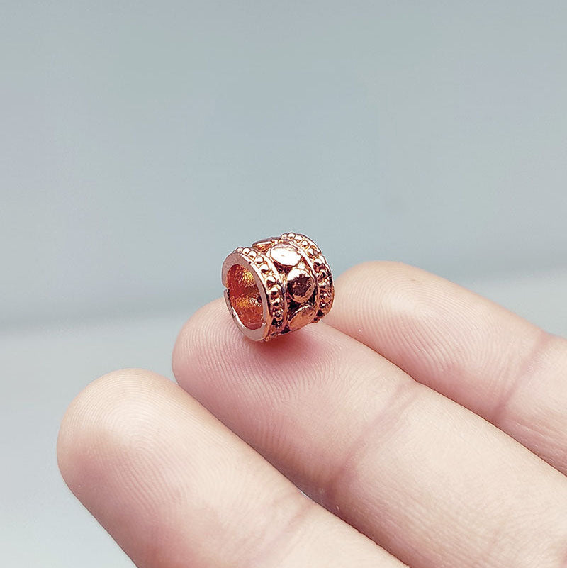 Decorative barrel spacer bead with dome detailing in rose gold overlay over copper, handcrafted in India