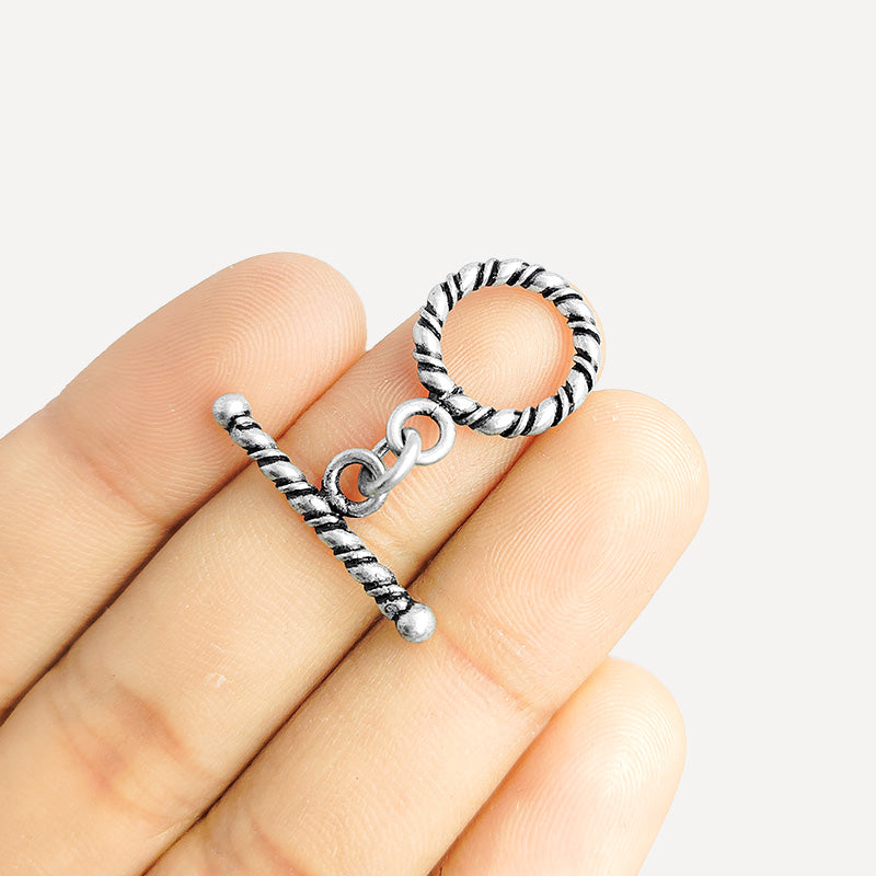 Decorative Silver Overlay toggle clasp with twisted rope bar and circular loop, oxidized finish, artisan jewelry fastener for bracelets and necklaces.