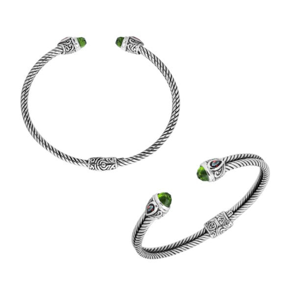 Handcrafted silver cuff bracelet with peridot quartz ends and garnet quartz accents in Bali design.