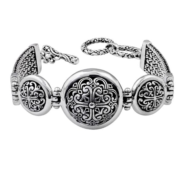 Sterling Silver artistic bracelet with round scrollwork panels, polished dome edging, and a smooth toggle closure reflecting elegant Balinese-inspired craftsmanship.