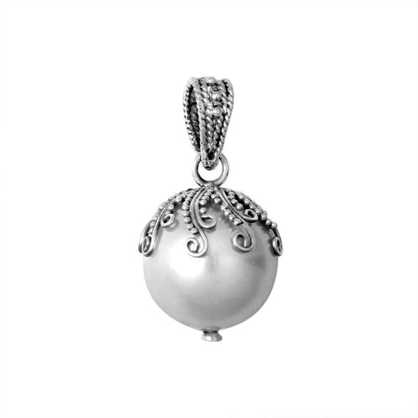 Elegant sterling silver shell pearl pendant with Balinese filigree detailing and oxidized handcrafted finish.
